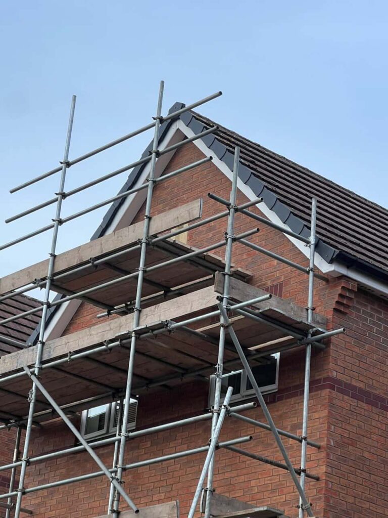 This is a photo of a roof which has just been repaired. There is a scaffold located at the gable end for access onto the roof. Works carried out by MCM Roofing Repairs Ringwood